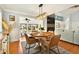 Open dining room with seating for four, modern chandelier, and views into the inviting living area at 39 Newport St., Ocean Isle Beach, NC 28469