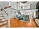 Bright living room with an open floorplan features wood floors, white walls, and comfortable seating at 39 Newport St., Ocean Isle Beach, NC 28469