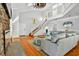 Inviting living room features soaring ceilings, a stone fireplace, and a staircase to the second level at 39 Newport St., Ocean Isle Beach, NC 28469