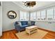 Cozy living room with a blue sofa, wood floors, and multiple windows for natural light at 39 Newport St., Ocean Isle Beach, NC 28469