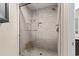 Modern walk-in shower with glass door features sleek, white tile and built-in shower accessories at 4396 Baldwin Ave. # 30, Little River, SC 29566