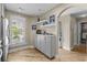 Light and bright dining area featuring a built-in buffet with decorative shelves, light wood floors, and natural light from the window at 4396 Baldwin Ave. # 30, Little River, SC 29566