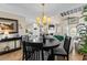 Elegant dining area with modern chandelier open to the living room, creating an inviting space at 4396 Baldwin Ave. # 30, Little River, SC 29566