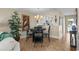 Cozy dining area with a dark wood table set, stylish lighting, and view to kitchen and living area at 4396 Baldwin Ave. # 30, Little River, SC 29566