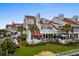 Beautiful condo with manicured lawn, red roof, and palm trees, offering a picturesque exterior at 4396 Baldwin Ave. # 30, Little River, SC 29566
