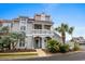 Charming two-story coastal home with a porch, featuring light gray siding and well-maintained landscaping at 4396 Baldwin Ave. # 30, Little River, SC 29566