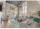 Comfortable living room featuring a high ceiling, fan, plush sofas, and natural light from sliding glass doors at 4396 Baldwin Ave. # 30, Little River, SC 29566