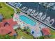 Aerial photo featuring a waterfront pool with marina access, deck chairs and shade umbrellas at 4396 Baldwin Ave. # 30, Little River, SC 29566