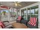 Inviting screened-in porch features cozy seating arrangements and views of the waterfront and community at 4396 Baldwin Ave. # 30, Little River, SC 29566