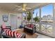 Cozy screened-in porch with ceiling fan, comfortable seating, shiplap walls, and views of the waterway at 4396 Baldwin Ave. # 30, Little River, SC 29566