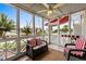 Relaxing screened-in porch offers views of the marina and surrounding community, with comfortable seating and a ceiling fan at 4396 Baldwin Ave. # 30, Little River, SC 29566