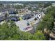 Aerial view of the neighborhood pool, clubhouse, and ample parking near the condominium buildings at 4486 Little River Inn Ln. # 2103, Little River, SC 29566