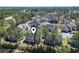 Aerial view of a well-maintained neighborhood surrounded by lush greenery and mature trees at 4486 Little River Inn Ln. # 2103, Little River, SC 29566