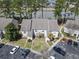 An aerial view of a condo building nestled among trees, near a tranquil lake and ample parking at 4486 Little River Inn Ln. # 2103, Little River, SC 29566