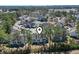 Aerial view of neighborhood with tennis courts, lush greenery, and a clear blue sky at 4486 Little River Inn Ln. # 2103, Little River, SC 29566