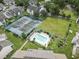 Aerial view of community amenities including tennis courts, pool, manicured landscaping, and clubhouse at 4486 Little River Inn Ln. # 2103, Little River, SC 29566