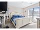 Cozy bedroom featuring a queen bed with striped bedding and natural light from a large window at 4486 Little River Inn Ln. # 2103, Little River, SC 29566