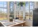 Bright sunroom dining area with large windows providing scenic outdoor views and ample natural light at 4486 Little River Inn Ln. # 2103, Little River, SC 29566