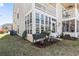 Charming exterior with a sunroom featuring multiple windows and manicured landscaping at 4486 Little River Inn Ln. # 2103, Little River, SC 29566
