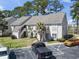 Well-maintained condo building with palm trees and ample parking on a sunny day at 4486 Little River Inn Ln. # 2103, Little River, SC 29566
