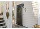 Charming front door with welcome sign, located at 2103, on a light-colored home at 4486 Little River Inn Ln. # 2103, Little River, SC 29566