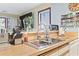 Well-maintained kitchen sink with a modern faucet and wood-style countertops near the window and spice rack at 4486 Little River Inn Ln. # 2103, Little River, SC 29566
