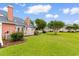 Spacious backyard with mature trees and a lush green lawn at 4505 Lightkeepers Way # 24B, Little River, SC 29566