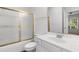 Bathroom features a white vanity, toilet, and a shower/bathtub combo with gold trim at 4505 Lightkeepers Way # 24B, Little River, SC 29566
