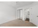 Bedroom featuring neutral carpet, mirrored closet, and door to bathroom at 4505 Lightkeepers Way # 24B, Little River, SC 29566