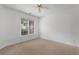 Bedroom featuring neutral carpet, a window with backyard views, and white walls at 4505 Lightkeepers Way # 24B, Little River, SC 29566