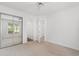 Bedroom featuring neutral carpet, mirrored closet, and a door to an additional room at 4505 Lightkeepers Way # 24B, Little River, SC 29566