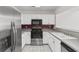 Well-lit kitchen featuring white cabinets and stainless steel appliances at 4505 Lightkeepers Way # 24B, Little River, SC 29566