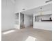 Open floor plan showcasing the stairs, a kitchen bar with stainless appliances, and neutral carpet at 4505 Lightkeepers Way # 24B, Little River, SC 29566