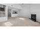 Open floor plan featuring a kitchen, stairs, and a fireplace with neutral carpet at 4505 Lightkeepers Way # 24B, Little River, SC 29566