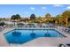 Tranquil outdoor pool area featuring sparkling blue water, comfortable lounge chairs, and palm trees, near the waterfront at 4505 Lightkeepers Way # 24B, Little River, SC 29566