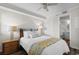 Bedroom with a full sized bed, ceiling fan, access to the bathroom, and dark wood floors at 4505 S Ocean Blvd. # 5D, North Myrtle Beach, SC 29582