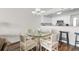 Cozy dining area with wicker chairs and view of the kitchen at 4505 S Ocean Blvd. # 5D, North Myrtle Beach, SC 29582