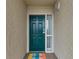A charming entryway with a painted front door, decorative sidelight window, and textured wall at 4505 S Ocean Blvd. # 5D, North Myrtle Beach, SC 29582