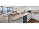 A well-equipped kitchen featuring sleek countertops, ample cabinet space, stainless steel dishwasher, and a view into the living room at 4505 S Ocean Blvd. # 5D, North Myrtle Beach, SC 29582