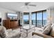 Well-lit living room showcasing ocean views and balcony access at 4505 S Ocean Blvd. # 5D, North Myrtle Beach, SC 29582