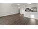 Inviting living space with wood-look flooring and kitchen with white cabinets and stainless appliances at 4510 Little River Inn Dr. # 2708, Little River, SC 29566