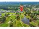 Scenic aerial view shows condo buildings next to a beautifully landscaped golf course with tranquil ponds at 4811 Orchid Way # 301, Myrtle Beach, SC 29577