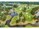 Expansive aerial view of a meticulously manicured golf course featuring lush greens and serene water features at 4811 Orchid Way # 301, Myrtle Beach, SC 29577