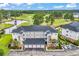 Scenic aerial view of condo complex overlooking a golf course and a pond, featuring a parking area at 4811 Orchid Way # 301, Myrtle Beach, SC 29577