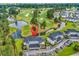 Scenic aerial view of condo buildings next to a beautiful golf course with lush greenery and water features at 4811 Orchid Way # 301, Myrtle Beach, SC 29577
