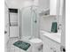 Well lit bathroom includes a glass shower, toilet, vanity, and stacked washer/dryer at 4811 Orchid Way # 301, Myrtle Beach, SC 29577