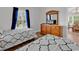 This bright bedroom features two twin beds, a dresser, and natural light at 4811 Orchid Way # 301, Myrtle Beach, SC 29577