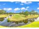 Scenic golf course view with a pond reflecting blue skies and green grass at 4811 Orchid Way # 301, Myrtle Beach, SC 29577
