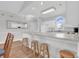 Bright kitchen with a breakfast bar, open to dining area and featuring white cabinets and countertops at 4811 Orchid Way # 301, Myrtle Beach, SC 29577