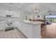 Bright kitchen with white cabinets, countertops, and appliances, open to dining and living areas at 4811 Orchid Way # 301, Myrtle Beach, SC 29577